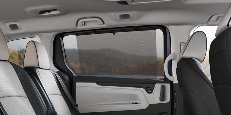 2027 Honda Odyssey Elite rear passenger seats featuring an integrated window sunshade (Minivan).